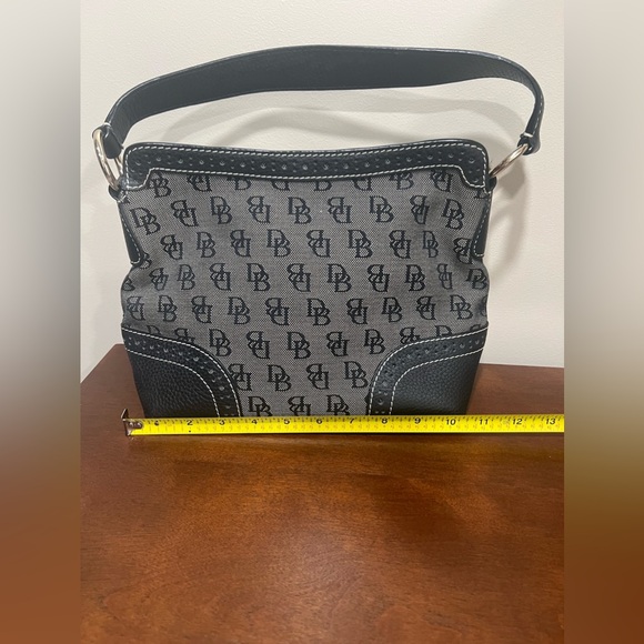 Dooney & Burke black logo printed fabric with black pebbled leather accents. - Picture 2 of 9